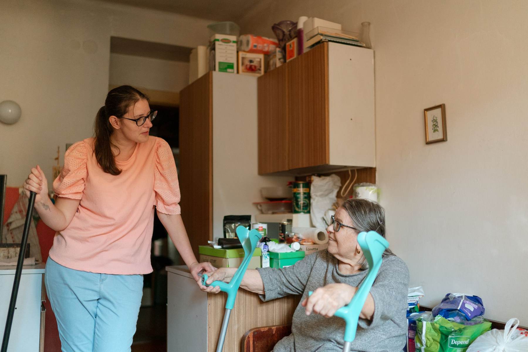 A carer supporting an older person in their home